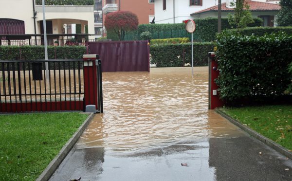 Entry Of A House During A Flood And Flooded Road